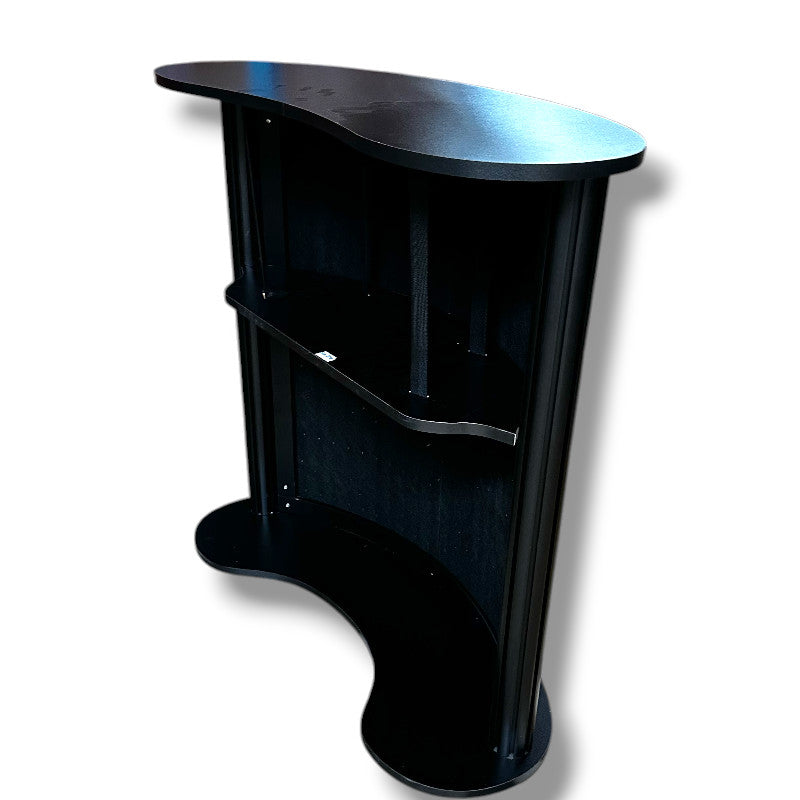 Kaareva levy hyllyllä. Etupuoli akustikkolevyllä / puulameleilla. L104 x S43 x K105 cm.