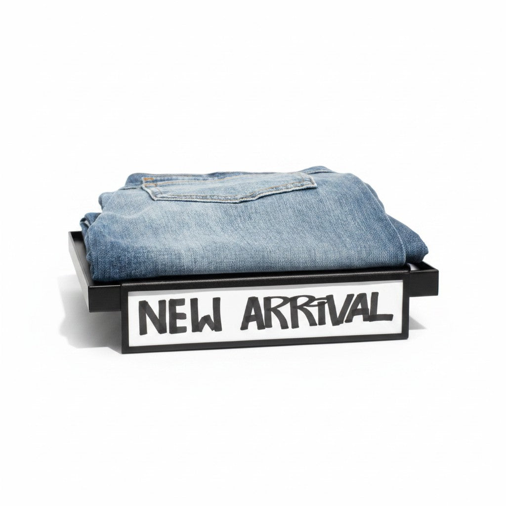 SuperSellerS black metal shelf edge sign holder displaying a New Arrival sign with folded blue denim jeans on top