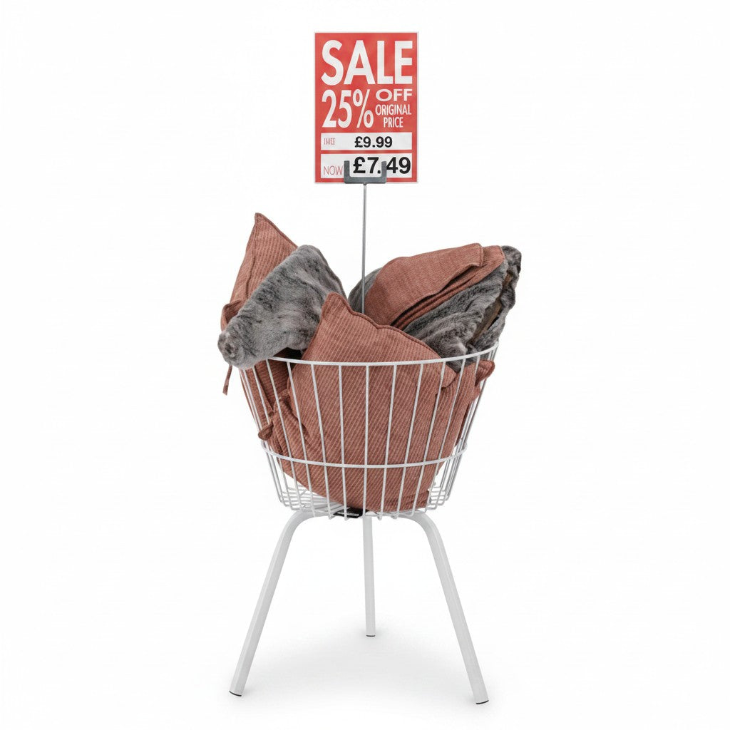 SuperSellerS white wire merchandiser basket with sign holder displaying sale cushions in a retail store setting